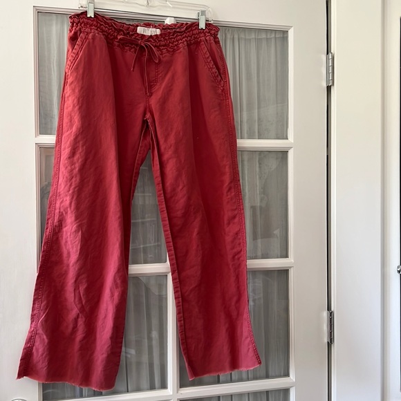 Faded red cotton drawstring beach pants, slash pockets, unfinished hem